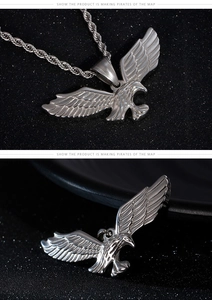 Detailed close-up of soaring eagle pendant with vintage textures and twisted steel chain