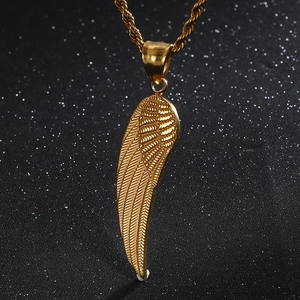 Gold angel wing pendant necklace with twisted chain on a dark starry background