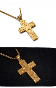 Detailed macro view of gold-plated cross pendant with map textured relief on rope chain