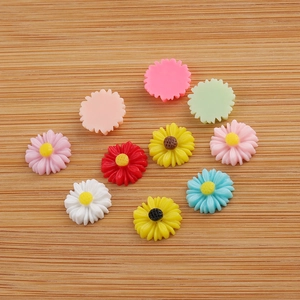 Colorful 12mm resin daisy flowers for DIY hair accessories scattered on wood surface