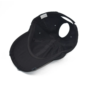 Distressed black cotton ponytail baseball cap with top opening and adjustable velcro strap