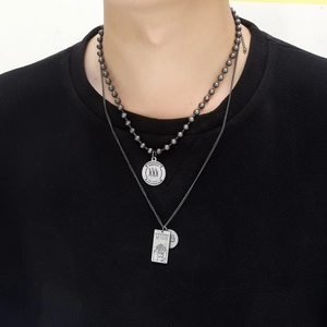Double-layered hip-hop necklace with round and rectangular pendants on a male model