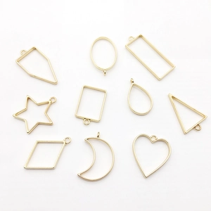 Set of 10 golden geometric hollow pendants for DIY jewelry making on white background