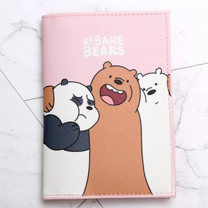 Pink PU leather passport holder featuring cartoon bear print on white marble surface