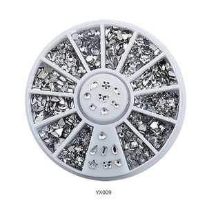 Detail of 12-grid wheel box containing silver nail art rhinestones and assorted shapes