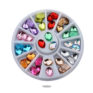 Detailed view of 12-slot storage wheel filled with assorted colorful faceted rhinestones