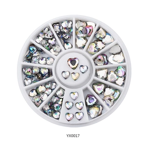 Detailed view of AB aurora heart-shaped nail art rhinestones in a white carousel wheel