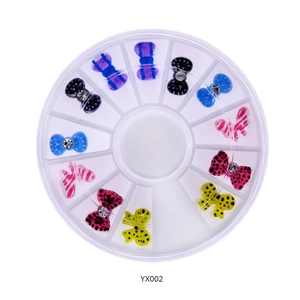 Detailed top view of butterfly nail rhinestones in assorted colors within a round wheel box