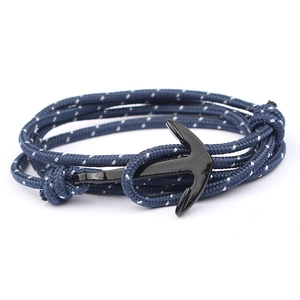 Multilayer navy blue nautical braided bracelet with a sleek black anchor clasp