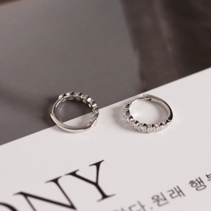 Macro shot of S925 sterling silver huggie earrings with sparkling zircon micro-pave setting