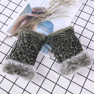 Detail of leopard print fingerless gloves with faux fur trim and lace-up tassel design