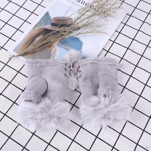 Detailed view of light gray fingerless gloves with lace-up ribbon and faux fur trim