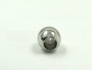 Macro detail of polished stainless steel beads with precision hole for jewelry making