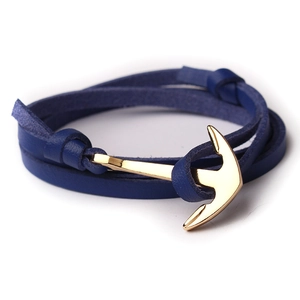 Detail of multi-wrap navy leather bracelet with a polished golden anchor clasp