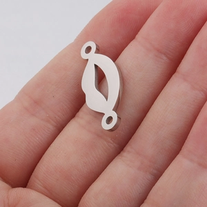 Mirror stainless steel sexy lip pendant for DIY jewelry, shown on a finger for scale