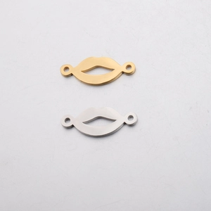 Detail of gold and silver lip-shaped metal connectors with dual attachment holes