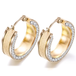 Detail of 8mm gold stainless steel hoop earrings with frosted finish and pavé zircons