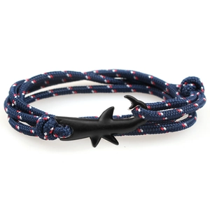 Detail of multi-strand tricolor braided cord bracelet with black shark hook clasp