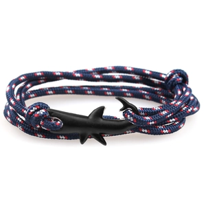 Close-up of tricolor braided rope bracelet featuring a black shark metal clasp detail