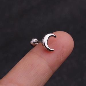 Silver stainless steel moon ear stud with ball screw back shown on a fingertip close-up