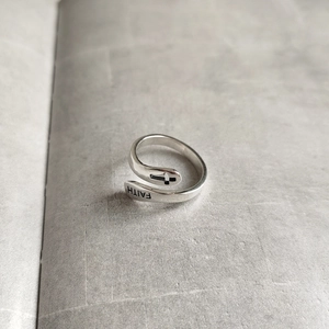 Close-up of 925 sterling silver ring featuring FAITH lettering and cross detail
