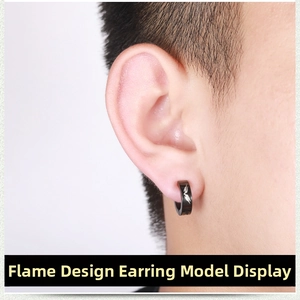 Close-up of black punk clip-on earring for men featuring a silver flame pattern design