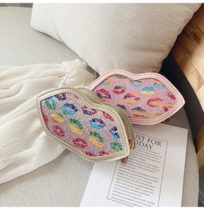Macro detail of lip-shaped glitter purses with colorful prints and gold chain straps
