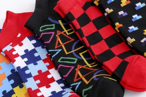Close-up of colorful cotton socks with puzzle, geometric, and checkered patterns