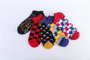 Detail view of five pairs of cotton low-cut socks with geometric and colorful patterns