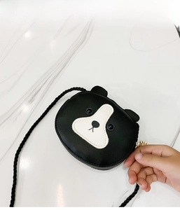 Close-up of mini cartoon bear crossbody bag in black leather with braided strap