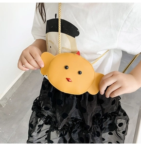 Little girl wearing a cute yellow cartoon chick crossbody bag with gold chain strap