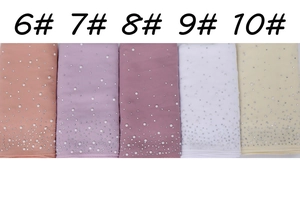 Detail of five chiffon scarves with pearl and rhinestone embellishments in various colors