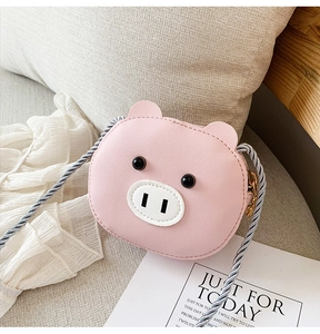 Detail of pink pig shaped PU leather mini crossbody bag with woven shoulder strap