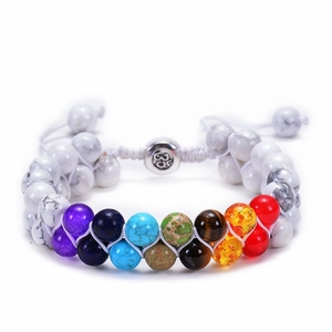 Detail of double-layer turquoise bead bracelet with 7 chakra stones and silver Om charm