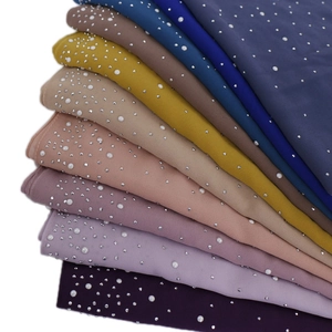 Detail of premium chiffon scarves featuring elegant pearl and rhinestone edge embellishments