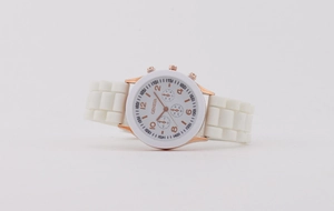Detailed close-up of white silicone strap quartz watch with rose gold dial markers