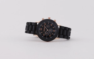 Close-up of Geneva women's watch with rose gold case and black silicone strap