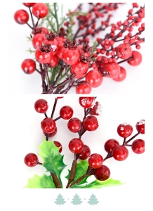 Close-up of artificial red berries with green leaves and frosted texture for Christmas DIY