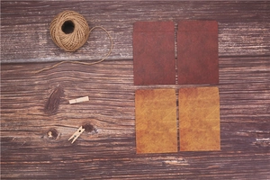 Flat lay of vintage Kraft paper envelopes and twine on a dark wood grain surface