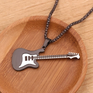 Elegant black electric guitar pendant necklace on a rustic wooden display tray