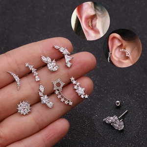 Star and flower zircon stainless steel cartilage piercings shown on hand and in ear