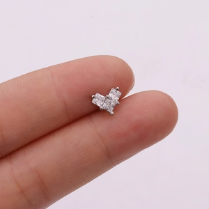 Macro shot of silver stud earring with three square-cut cubic zirconia in a triangular shape