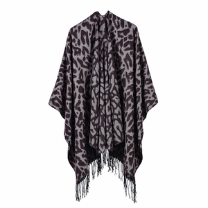 Detail of grey leopard print shawl with fringe hem and warm knitted fabric texture