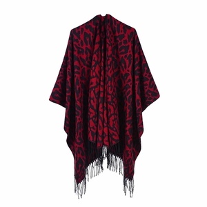 Detail shot of red and black leopard print shawl with fringe on a white background