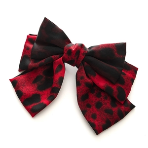 Red and black leopard print satin bow hair clip with multi-layered fabric design