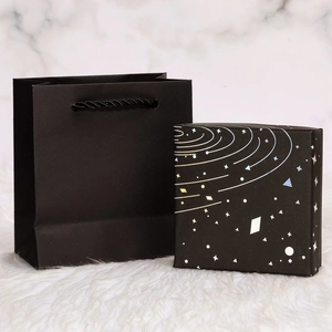 Starry sky gift box and black paper bag set for jewelry on marble background