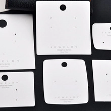 Detailed display of white jewelry cards with various hole layouts for earrings and necklaces