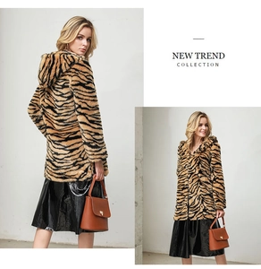 Detail view of tiger print faux fur hooded coat showing plush texture and fit from multiple angles