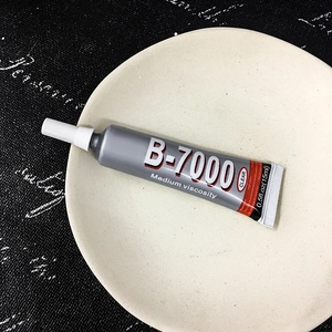 Macro shot of B-7000 clear adhesive 15ml tube for jewelry repair and DIY projects