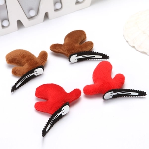 Set of festive red and brown plush reindeer antler hair clips on a white surface